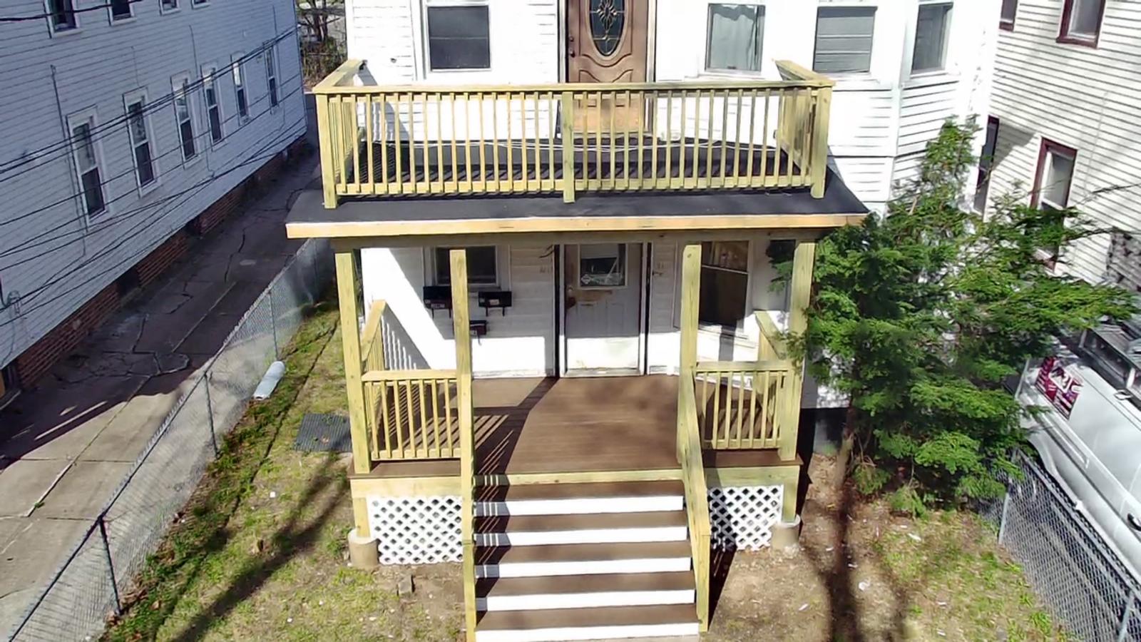Rebuilt covered porch and deck with stairs on an M2J project