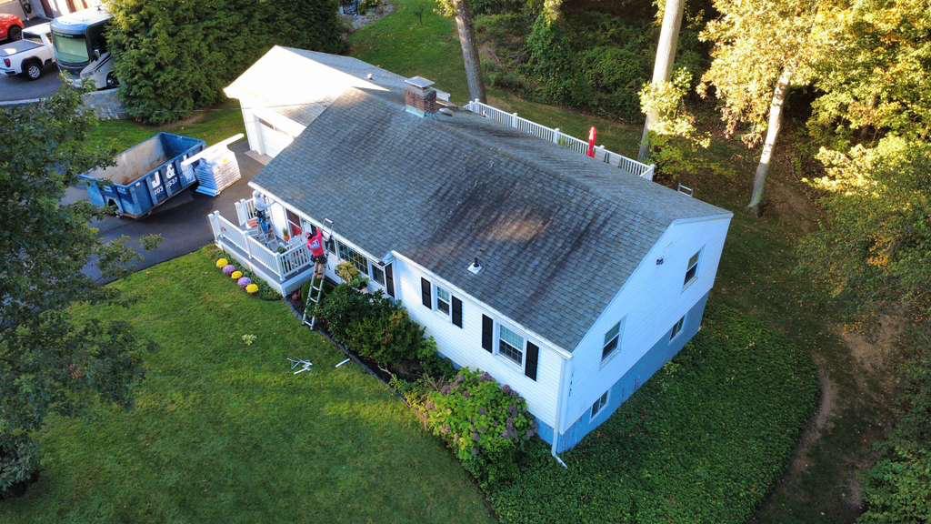 Gray home exterior with new roof and deck
