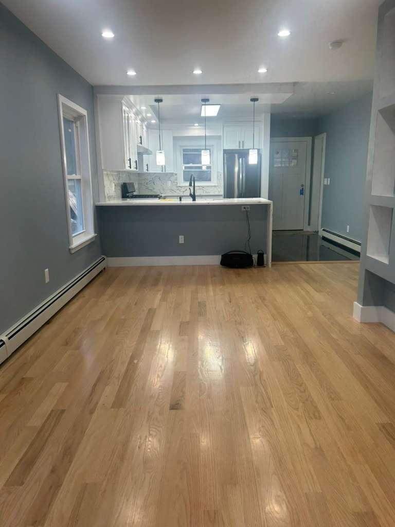 Open remodeled living and kitchen area with hardwood floors
