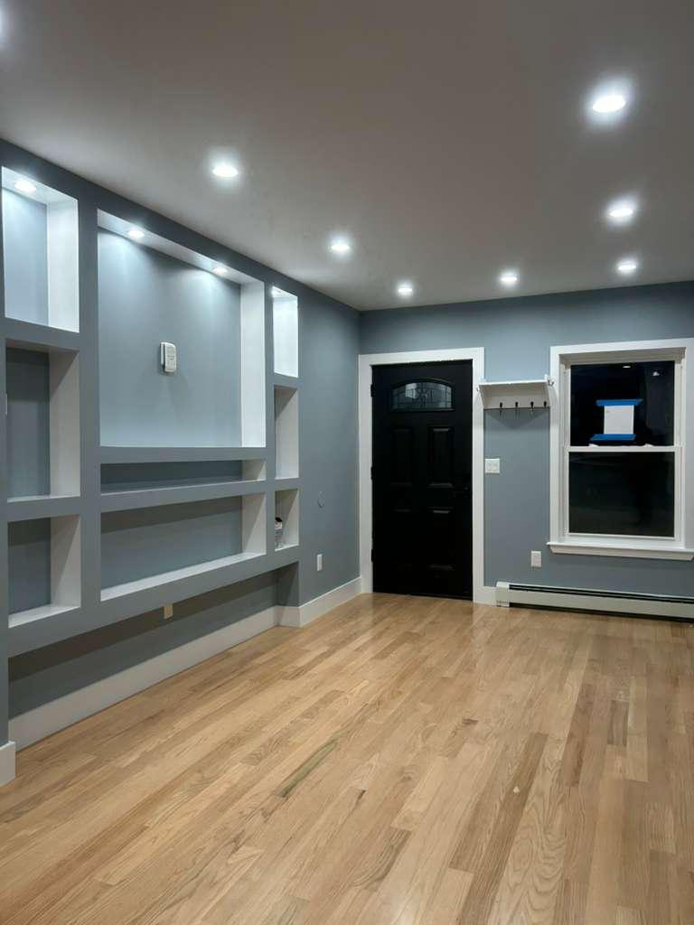 Remodeled living room with hardwood floors and recessed lighting