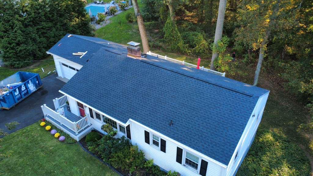 Aerial of a completed re-roof on a blue Connecticut home