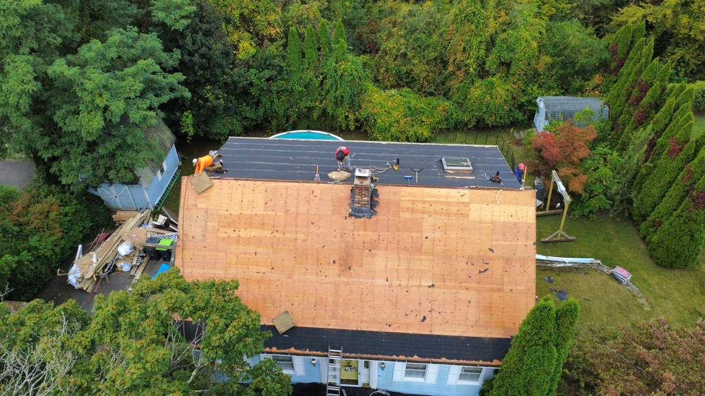 Aerial of a roof deck covered in fresh underlayment before shingles