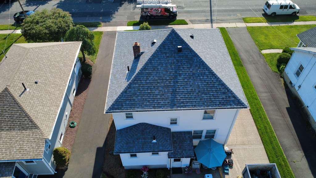 Aerial of a completed re-roof with a new dark shingle roof on a Connecticut home