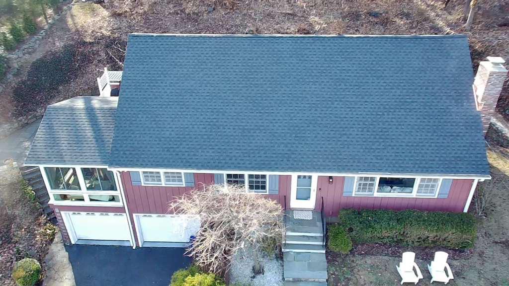 Aerial of a home with a freshly installed dark roof