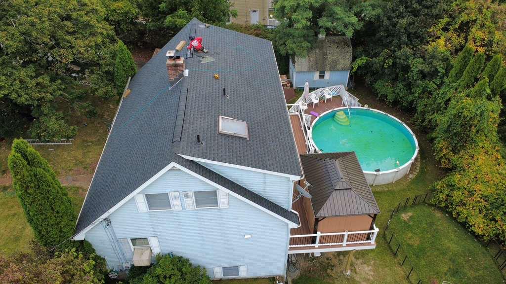 Aerial of a completed roof on a home with a pool