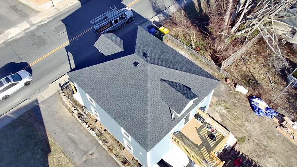 M2J crew working a roof with a skylight opening cut in