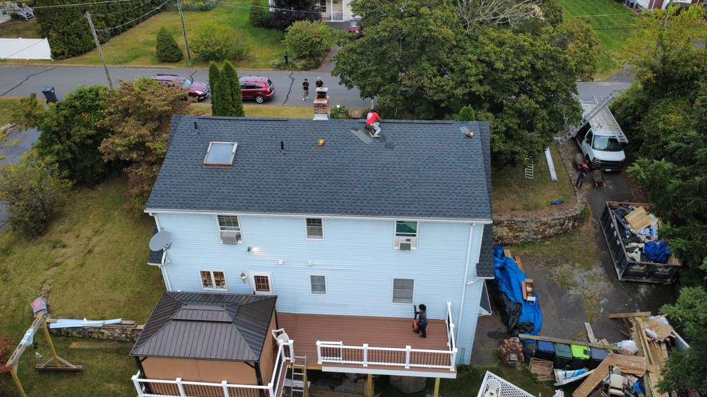 Aerial of a two-story home during roof replacement
